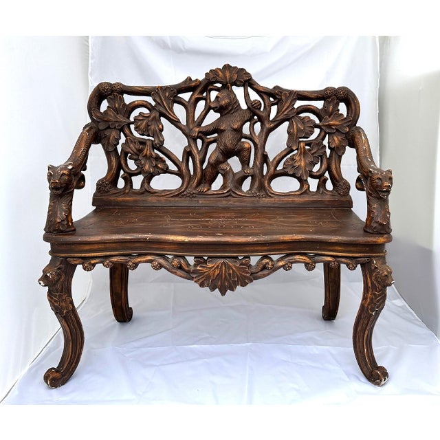 Black Forest style reproduction bench made of fiberglass. Quite heavy. Back of bench has embossed detail of a bears...