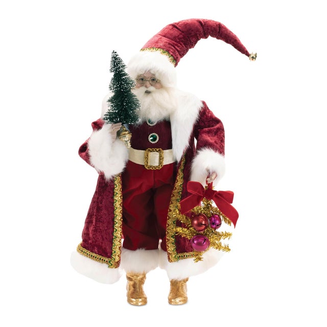 Bring nostalgic holiday charm to your decor with this Holiday Santa with Pine Tree Character. This festive figure features...
