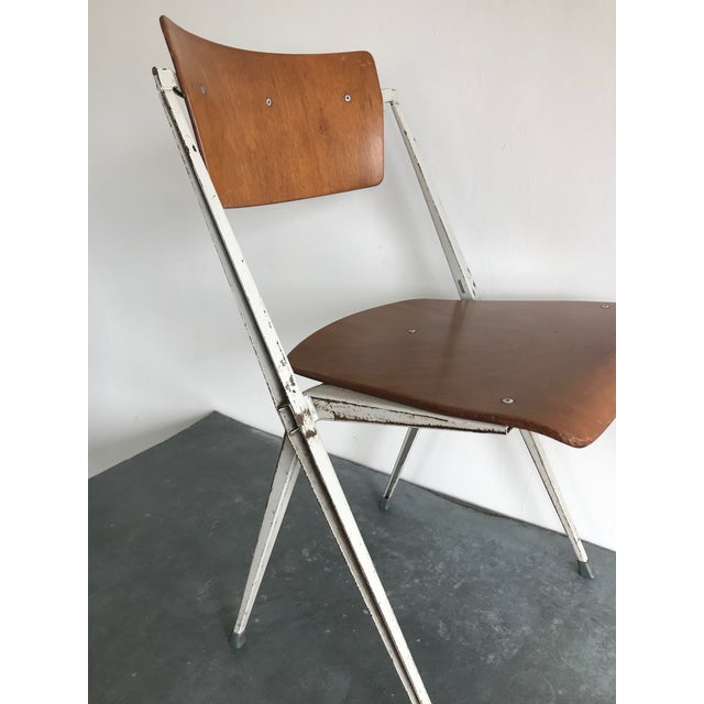 One mid-century Friso Kramer chairs. (Two available for additional $680)