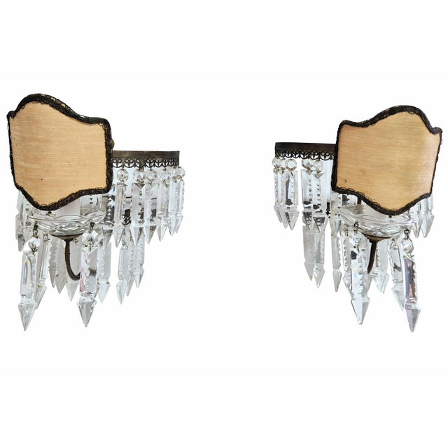 A pair of classic-style wall lamps, crafted with a burnished bronze frame and a rich array of cut crystals. The lamps...