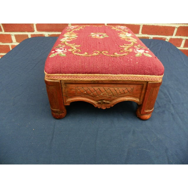 Antique French Walnut Needlepoint Stool in good estate condition. There are some minor cracks and pulls to the...