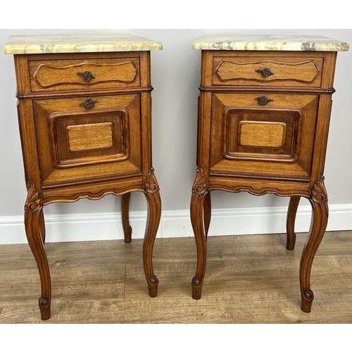 A charming pair of Antique French Louis style bedside tables , beautifully designed with elegant curves and a refined...