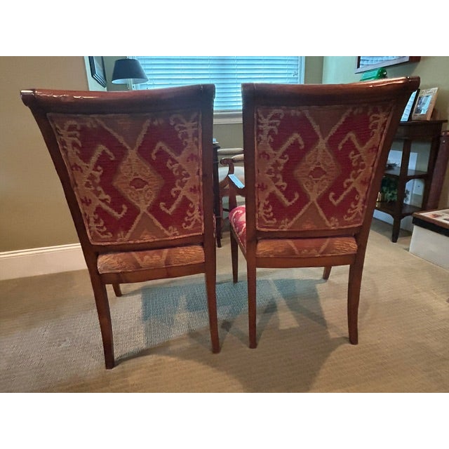 Pair of french style dining or game table chairs with tapestry upholstery. Curved back, curved arms wood arms and cabriole...