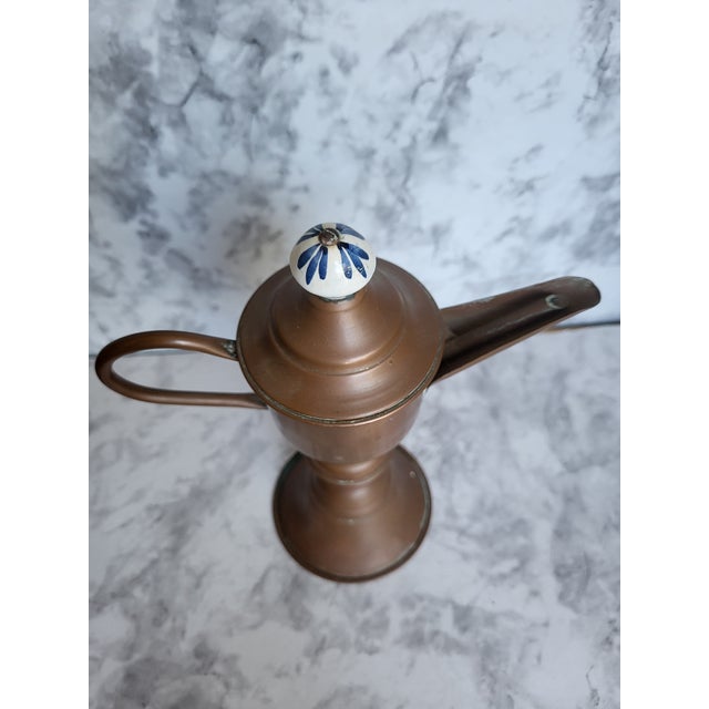 This is a copper/brass snotneus (snotnose) whale oil lamp. It has a pedestal base and a lidded resevoir with a distinctive...