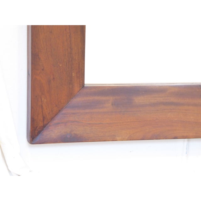 This modern hardwood mirror has a 4" wide molding and measures 31"H x 25"W.