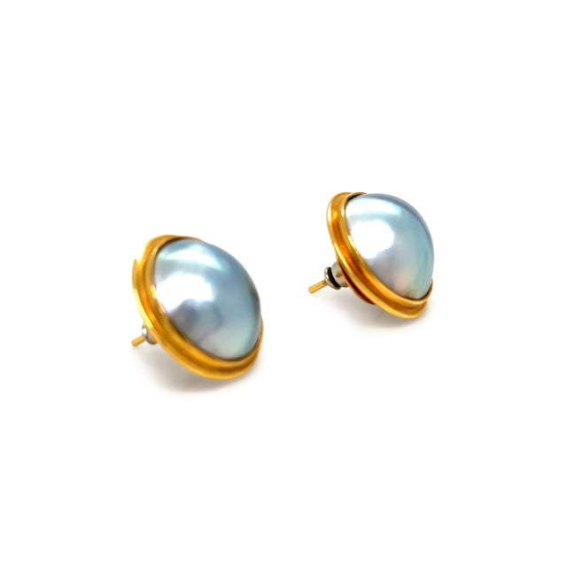 A classic pair of mabe Tahitian pearl earrings crafted in 18ct yellow gold, showcasing large lustrous pearls with...