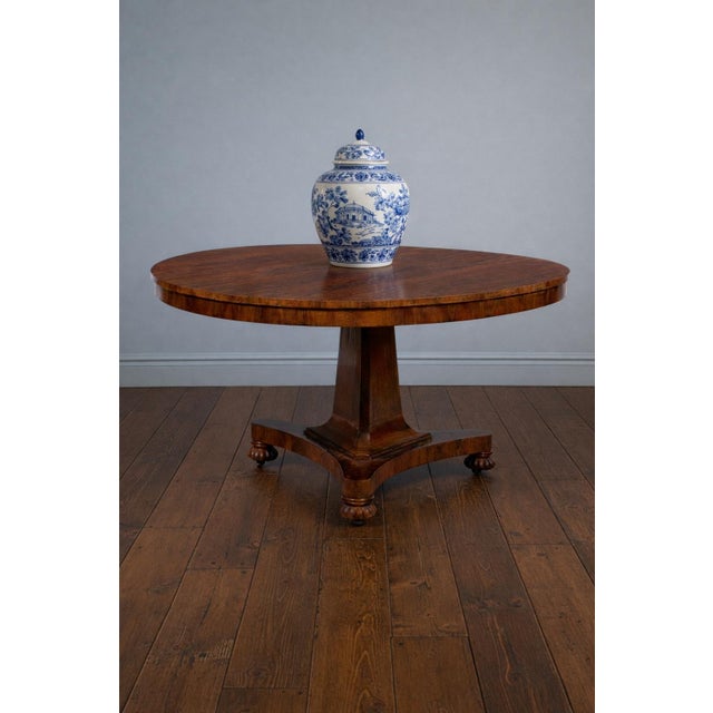 An exceptional 19th-century William IV rosewood tilt-top center table featuring some of the most dramatic "butterfly"...