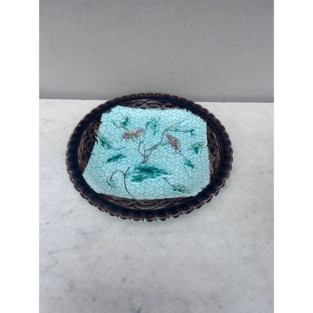 German Majolica plate with morning glory on a blue basket weave and a brown border, circa 1900.