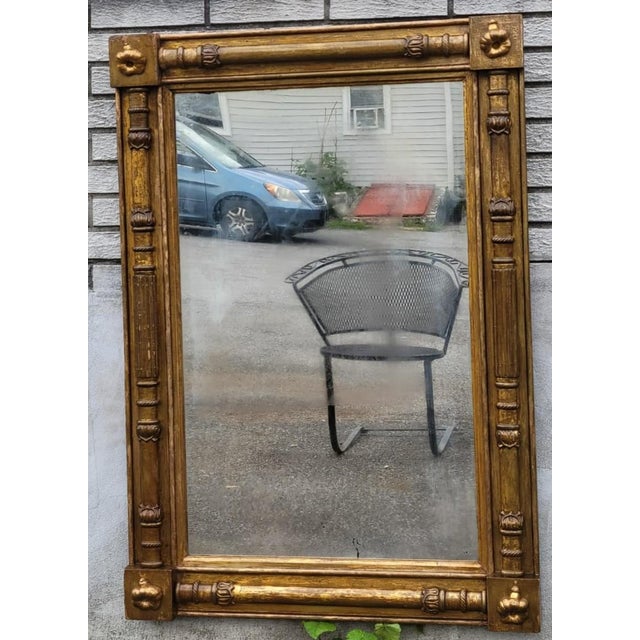 Authentic early 19th-century American Federal giltwood wall mirror, circa 1820. Features its original hand-carved gilt...