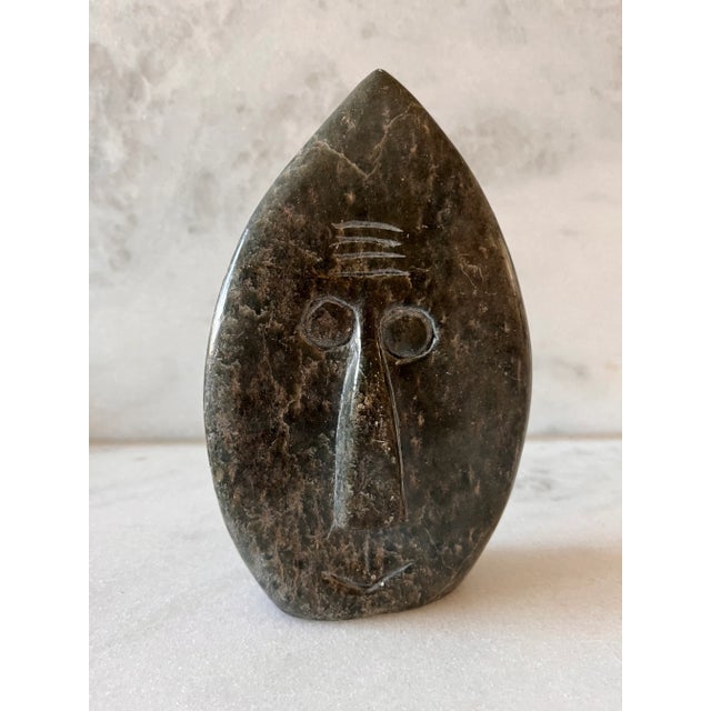 Vintage hand carved stone sculpture of a face. Face is on both sides of piece. Signed by artist "F Mupfawa" for Fanny...