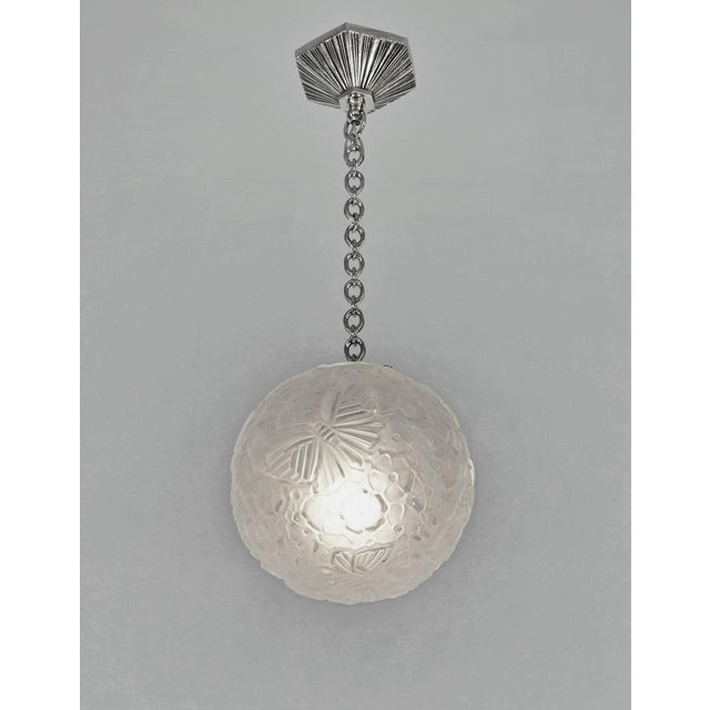 Hettier & Vincent A French 1925-1935 art deco chandelier by Hettier et Vincent in nickel plated bronze. The fixture holds...
