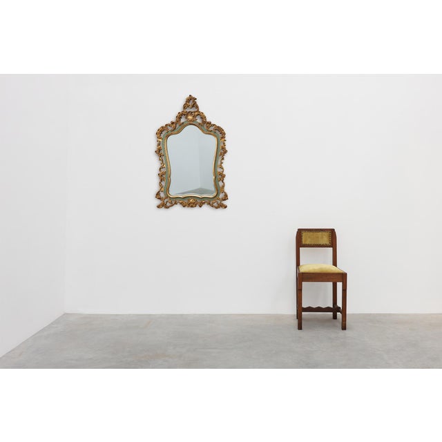 Elegant Italian wall mirror in the Florentine style, distinguished by its richly detailed openwork frame adorned with...