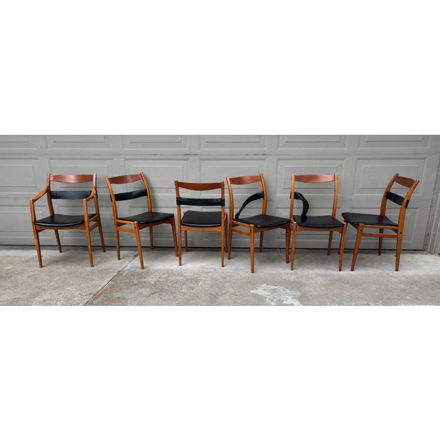 Rare lot of six Yngve Ekström designed "Remus" teak frame and leather back strap dining chairs for DUX. The seats have...