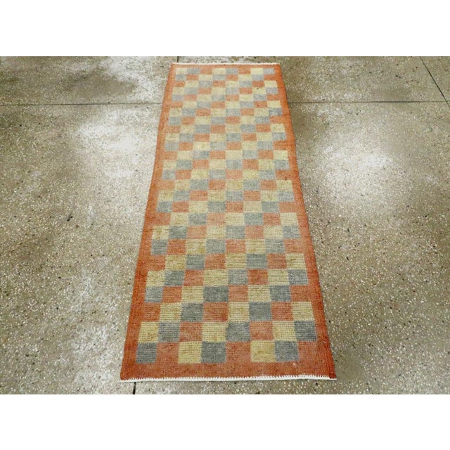 A vintage Turkish Anatolian rug. This can be used as a tiny runner. The allover, squares pattern has a diagonal...