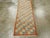 A vintage Turkish Anatolian rug. This can be used as a tiny runner. The allover, squares pattern has a diagonal...