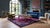 This early 20th-century Chinese Art Deco rug features a rich, deep plum field framed by a contrasting navy blue border....