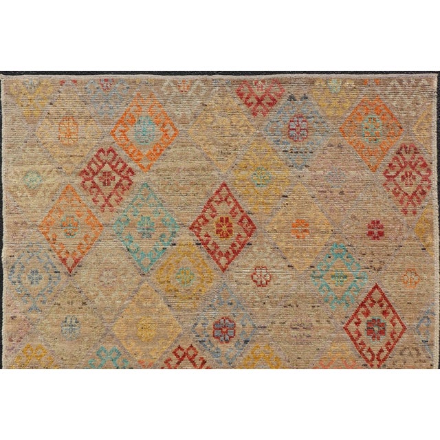This modern casual tribal rug has been hand-knotted. The rug features a modern sub-geometric diamond design rendered in...