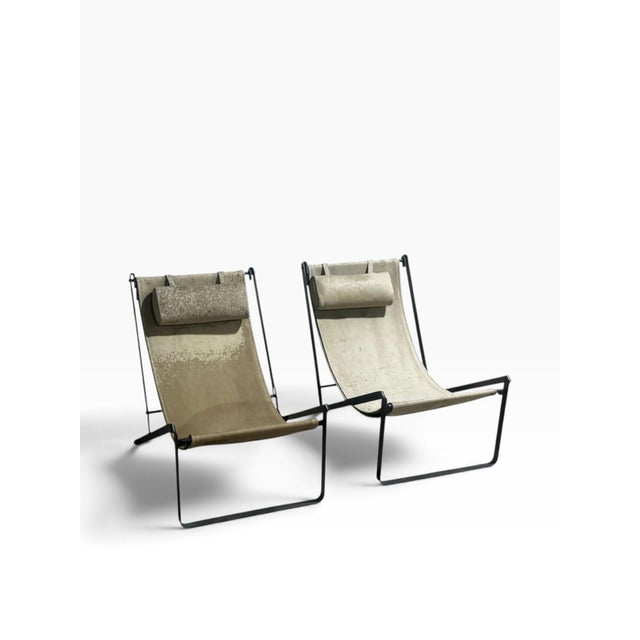 Pair of sling chairs by Roman and Williams Guild in blackened steel and leather. While unmarked, these chairs were part of...