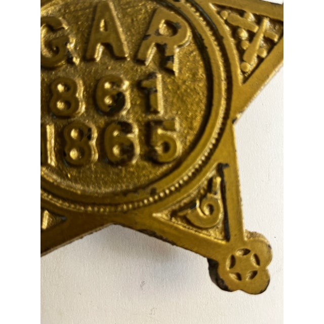 Antique G.A.R. 1861 1865 cast iron star painted gold. Hanging holes in the back.