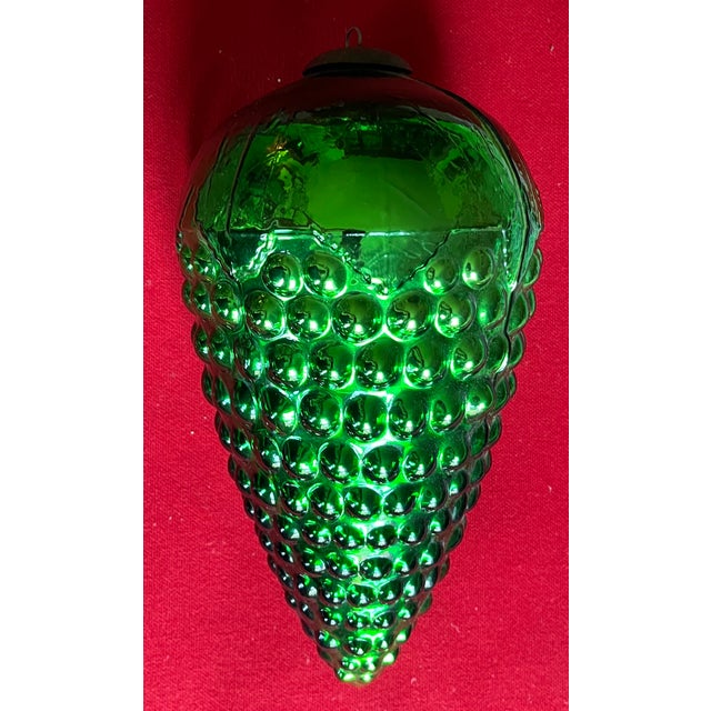 Large 13 1/4" green mercury glass Christmas kugel ornament in the form of a grape cluster. With metal ring at the cap for...