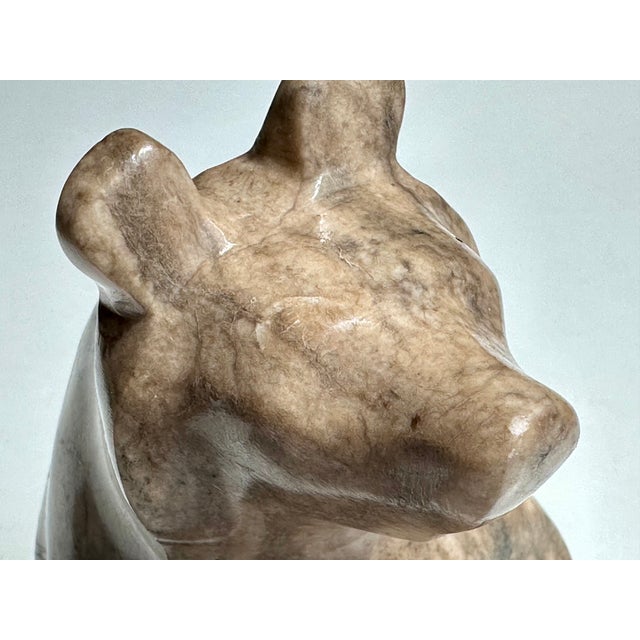 This decorative, hand-carved soapstone bear showcases the warm, organic beauty of the material in a particularly...