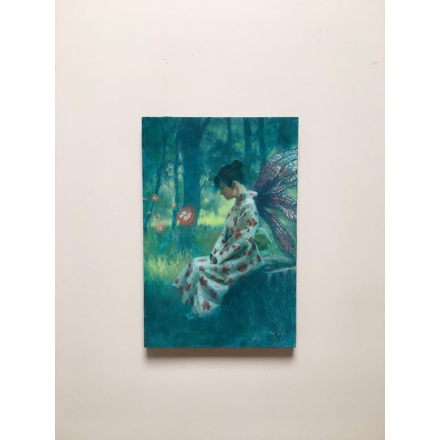 This oil painting depicts a serene figure seated in a lush, ethereal forest, adorned with delicate butterfly wings and...