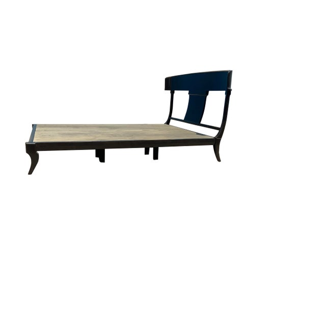 Modern Klismos style queen bed. The bed is made of alder with a rich deep walnut stain. The bed is a platform style bed....