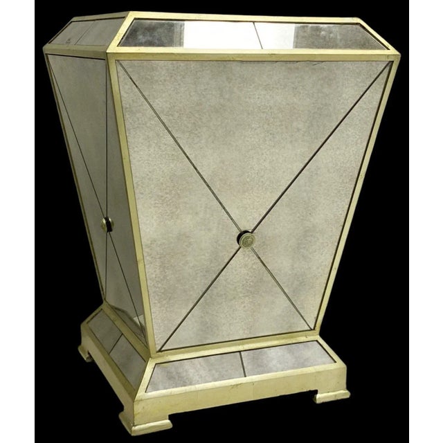 This is a pair of neo-classical style mirrored side tables or pedestals. They have brass plated accents. The pair are...