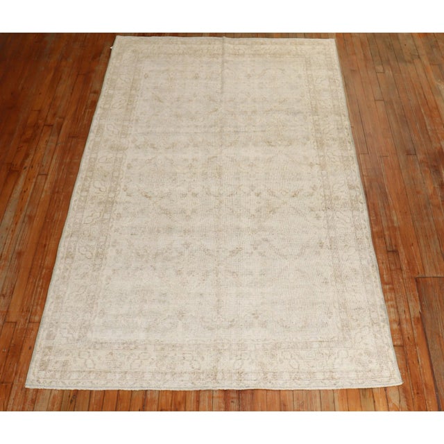A mid 20th Century handknotted light green and ivory worn turkish rug. This piece is a true vintage one of a kind rug that...
