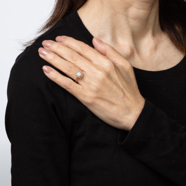 Finely detailed antique Victorian era opal & diamond ring (circa 1880s to 1900s) crafted in 10k yellow gold. Opal cabochon...