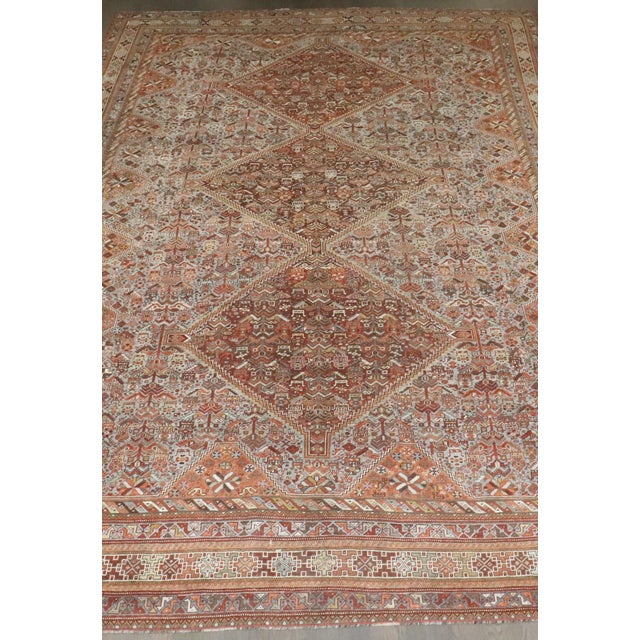 A tribal room-size Persian Shiraz rug from the early 20th century
