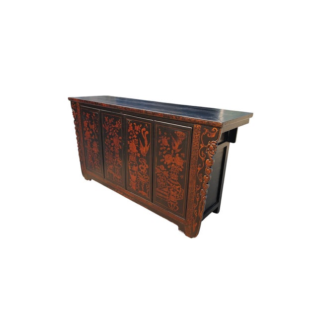 This 20th century elm sideboard features intricate hand-painted detailing. The front is configured with four cabinet doors...