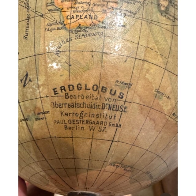 Rare and unusual early 20th century globe by Paul Oestergaard on ebonized turned wood stand. Small compass attached at...