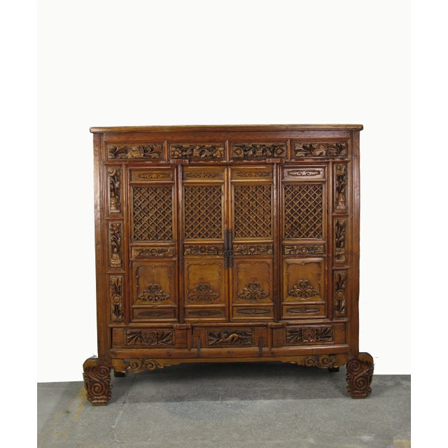 This striking antique Chinese cabinet is hand carved, a true masterpiece of craftsmanship. The fronts of 4 drawers on top...