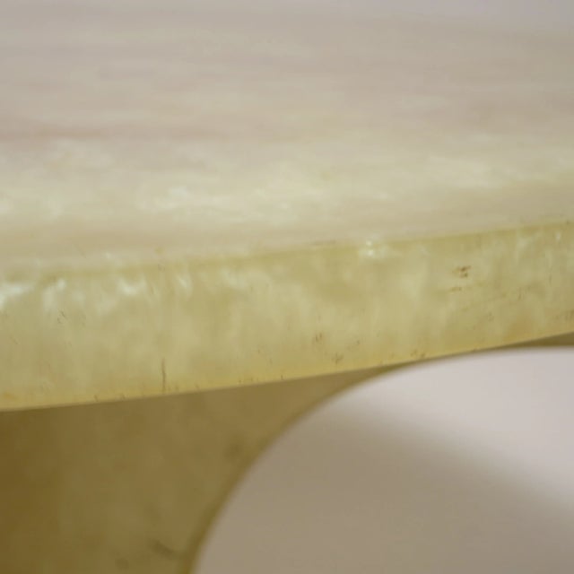 Coffee table manufactured around 1970 in a style reminiscent of Pierre Giraudon. It is made from thick pale yellow resin...