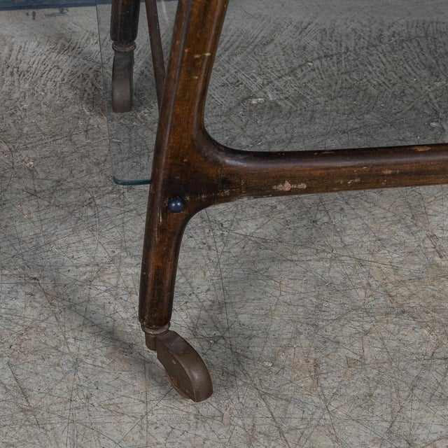 A delightful mid century italian drinks trolley in the manner of cesare lacca. The two tier cart is realised entirely out...