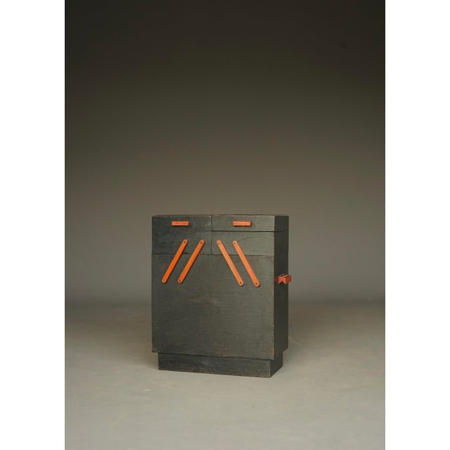 Striking small sewing box with two pull out elements . Typical 1930s design with some small compartments on top and larger...