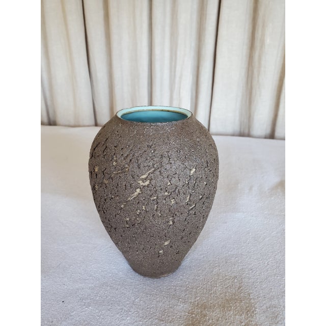 This is a beautiful little vase with no markings, so it may have been a practice piece in a studio. Still, it's lovely and...