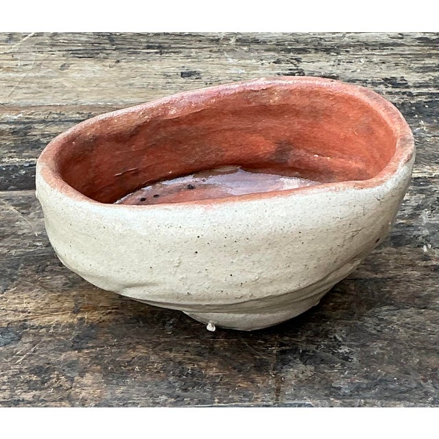 This striking original studio pottery bowl is a masterclass in organic modernism, showcasing a hand-built, biomorphic...
