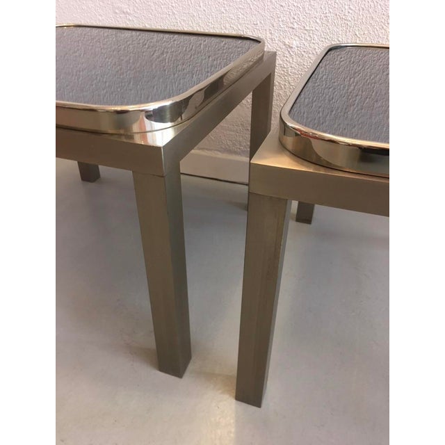 Very elegant pair of side tables in brushed metal, chrome and glass typical of the 70s. Designer or manufacturer unknown.