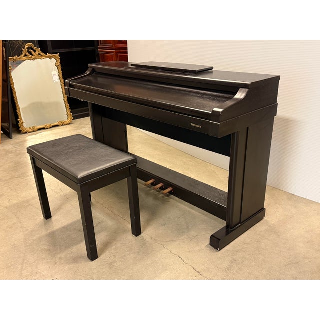 Design Plus Gallery presents a Digital Piano + Padded Bench from Technics. This model has a full-size 88-key keyboard...