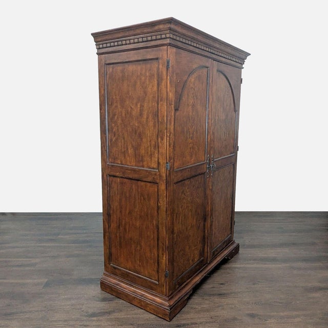 Armoire cabinet with storage for 30 wine bottles, glassware, glass shelf, and additional wood shelves. Brand: Howard...