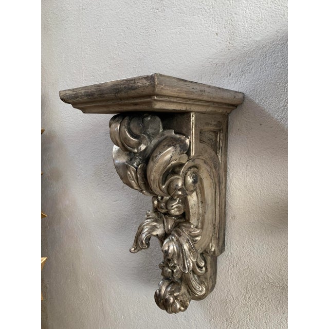 Amazing pair of handcrafted carved brackets made from birch wood and finishided with a polish of silver leaves. Bracket...