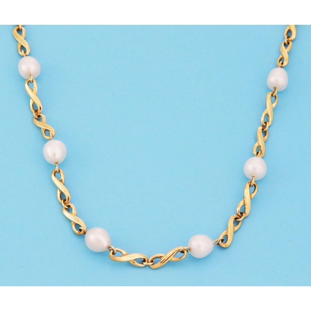 Elegance meets sophistication with the Mikimoto Pearls 18k Yellow Gold Infinity Link Necklace. Crafted with precision,...