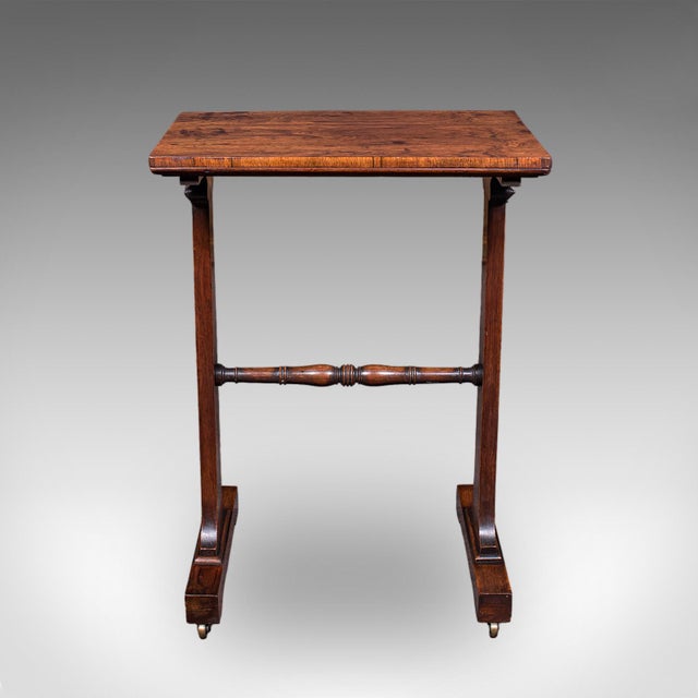 This is an antique side table. An English, rosewood morning room table, dating to the Regency period, circa 1820....