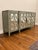 Architectural without feeling heavy, this contemporary four-door credenza features geometric mirrored doors in a soft...