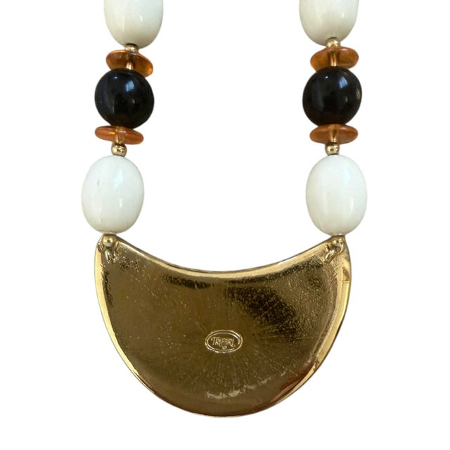 This is an amazing mid-century costume necklace stamped Trifari. Beaded with lucite beads with a tri-color enamel pendant....
