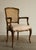 A finely carved French Louis XV style armchair by Kindel Furniture, with a serpentine caned back framed in molded walnut,...