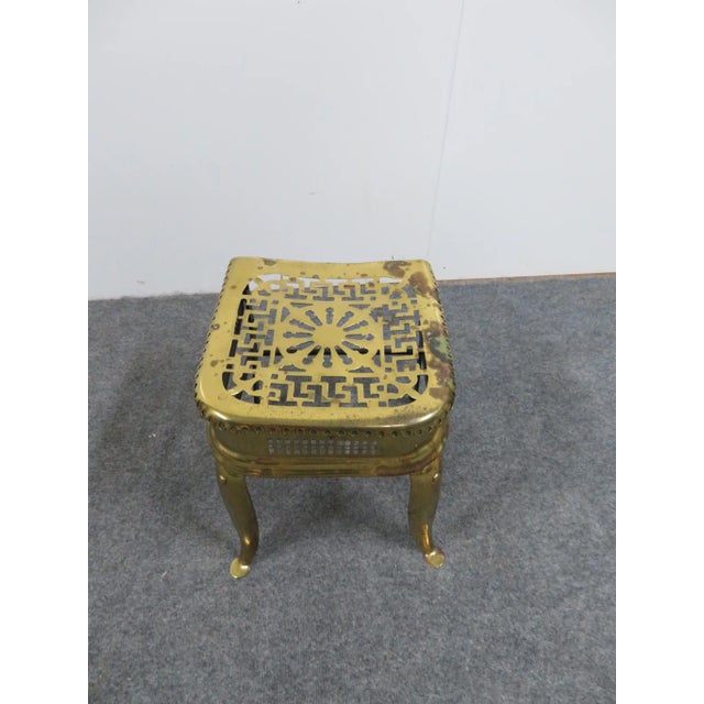 Fireplace trivet, reticulated brass top and side , front brass cabriole legs rear legs iron with iron framework.