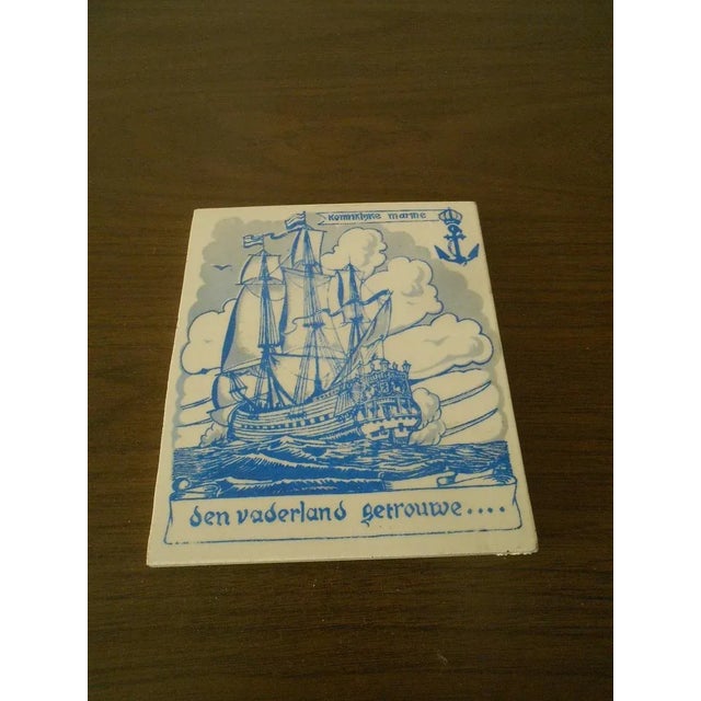 This marvelous antique Sphinx brand Made in Holland tile is created in gorgeous white ceramic that is glazed with blue and...